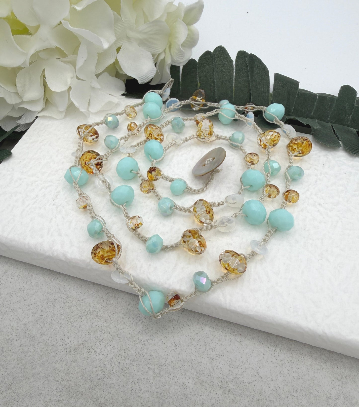 A Long Crocheted Necklace with an Ivory Cord With Aqua, Gold and Mily White Czech Glass Ronds SN-685