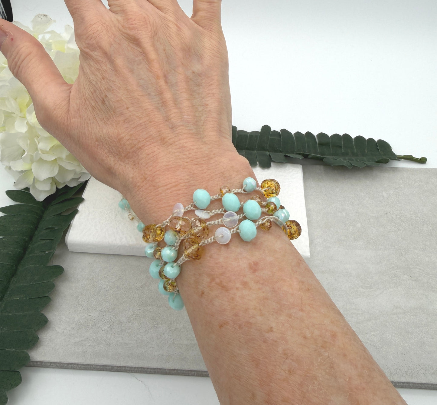 A Long Crocheted Necklace with an Ivory Cord With Aqua, Gold and Mily White Czech Glass Ronds SN-685