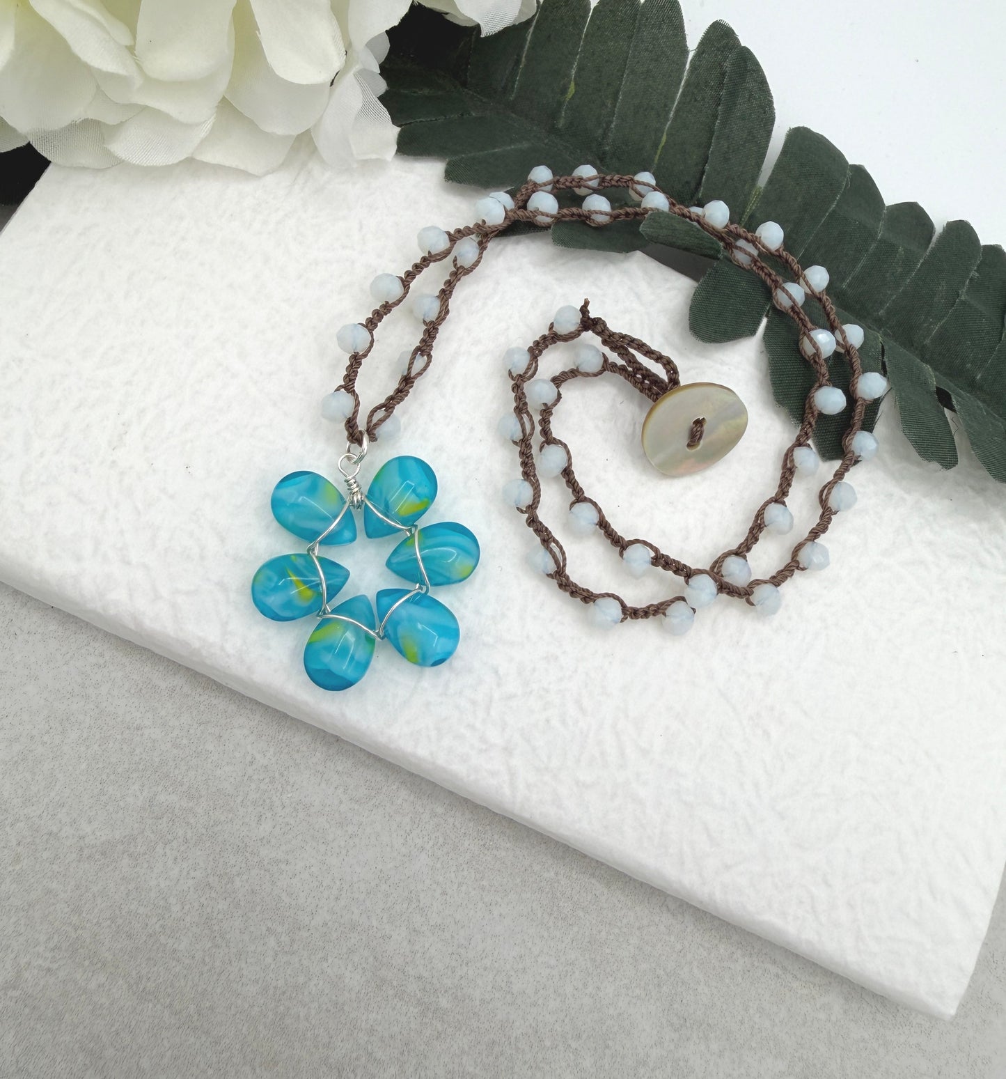 Crocheted Necklace with a Brown Cord, White Crystals and a Blue and Yellow Glass Teardrop Flower SN-688