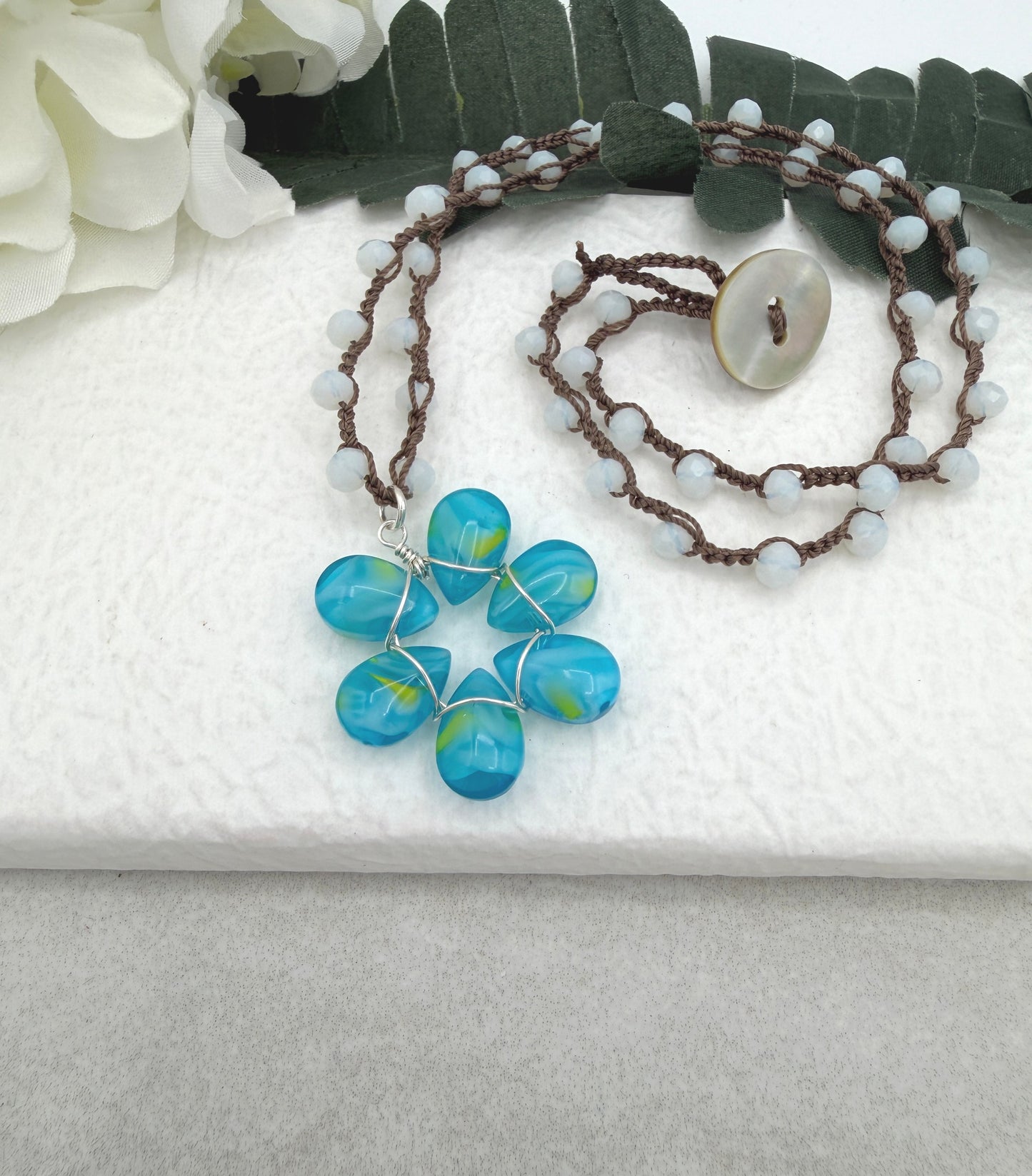 Crocheted Necklace with a Brown Cord, White Crystals and a Blue and Yellow Glass Teardrop Flower SN-688