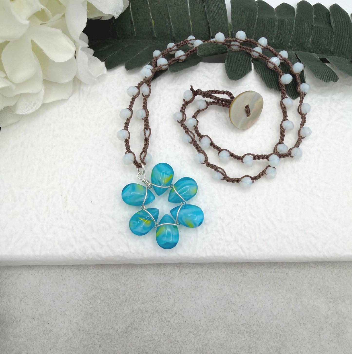 Crocheted Necklace with a Brown Cord, White Crystals and a Blue and Yellow Glass Teardrop Flower SN-688