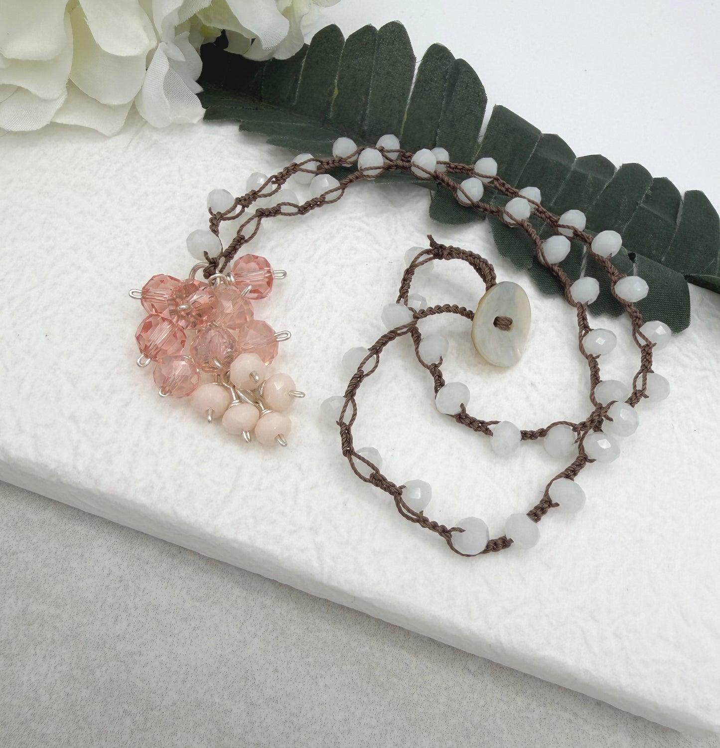 Crocheted Necklace with a Brown Cord, White Crystals and a Cluster of Pink, Peach and Cream Crystals SN-689