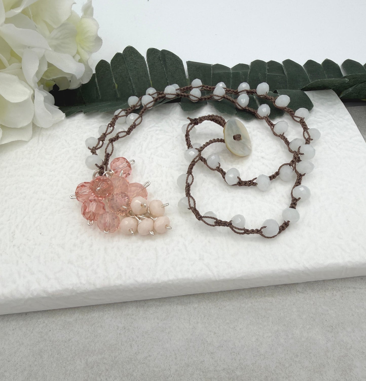 Crocheted Necklace with a Brown Cord, White Crystals and a Cluster of Pink, Peach and Cream Crystals SN-689