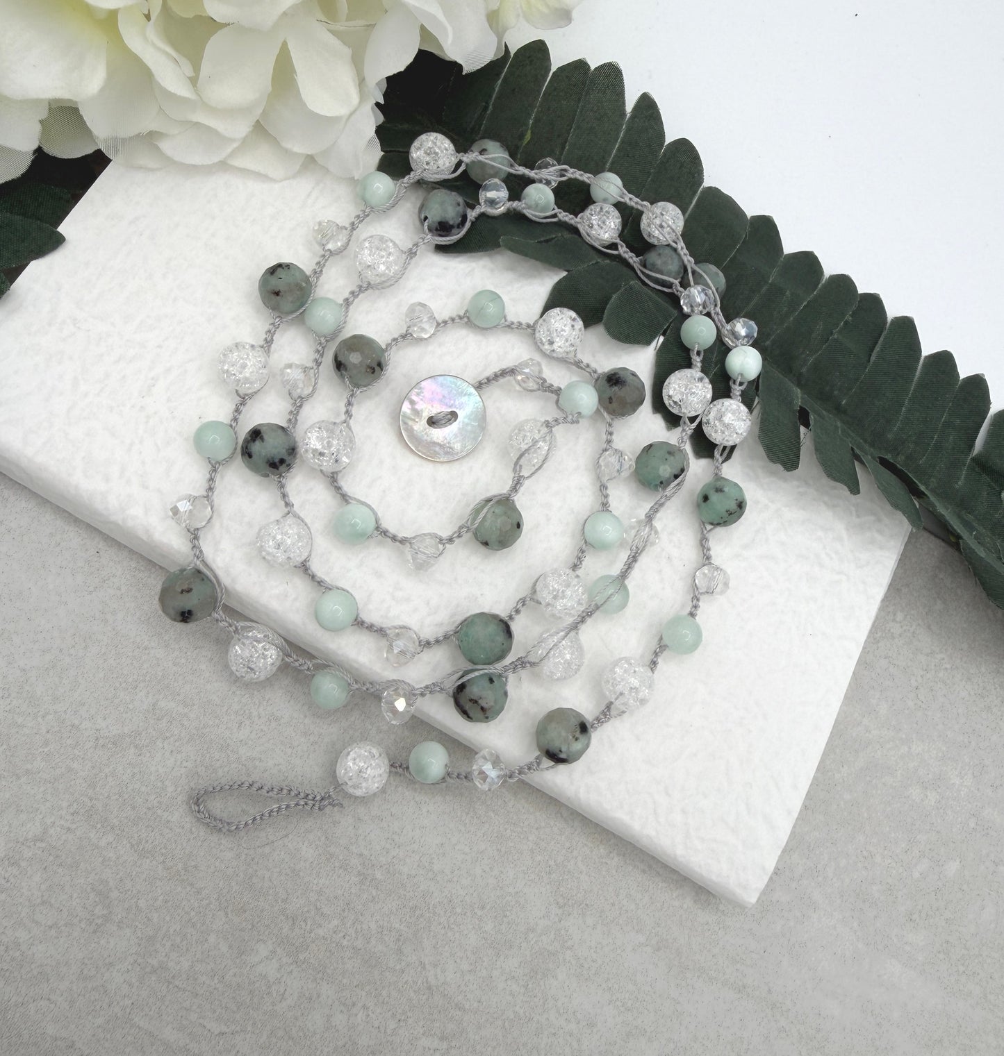 A Long Crocheted Necklace with a Light Gray Cord With Agate, Crackled Quartz and Crystal Beads SN-694
