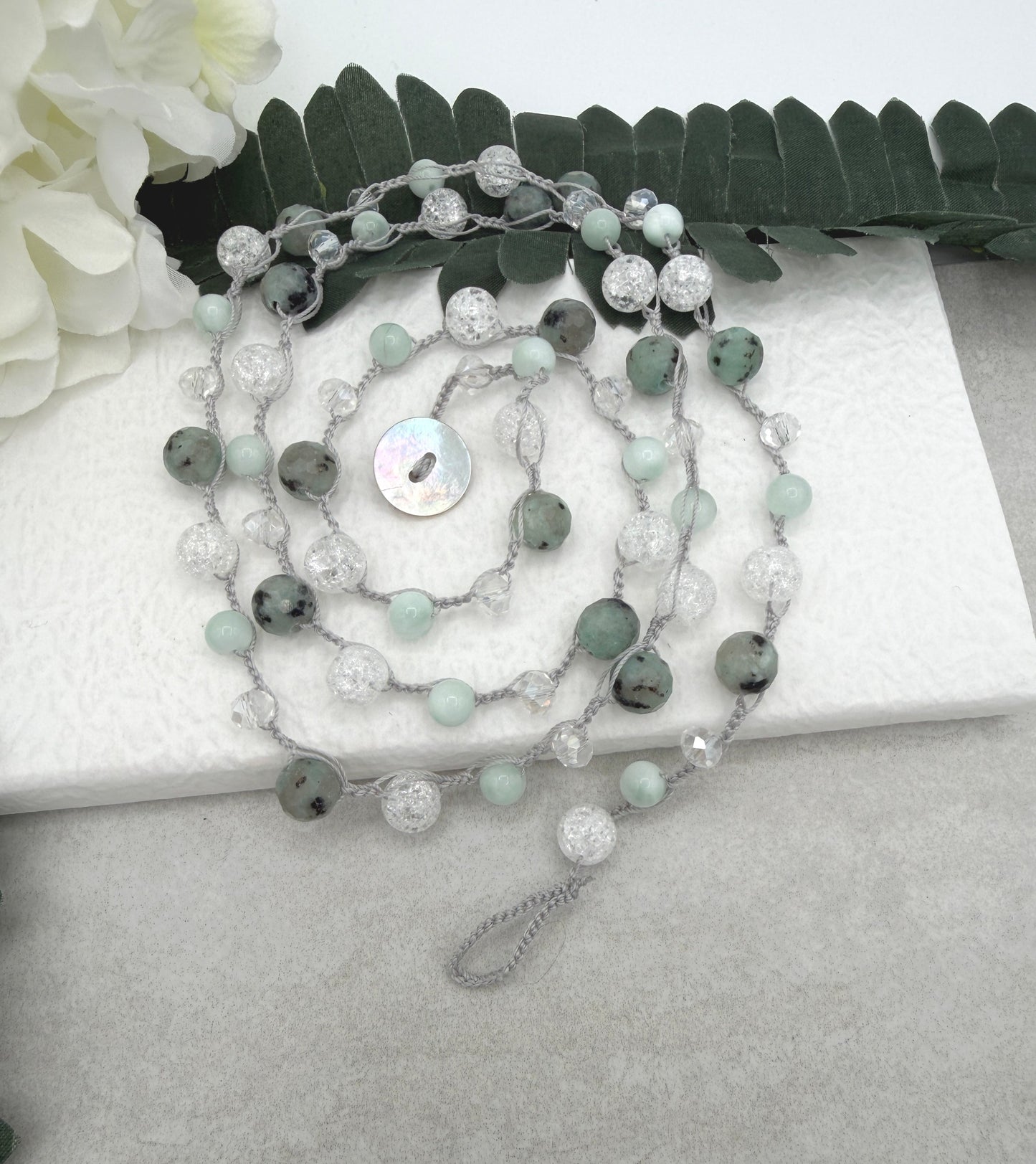 A Long Crocheted Necklace with a Light Gray Cord With Agate, Crackled Quartz and Crystal Beads SN-694