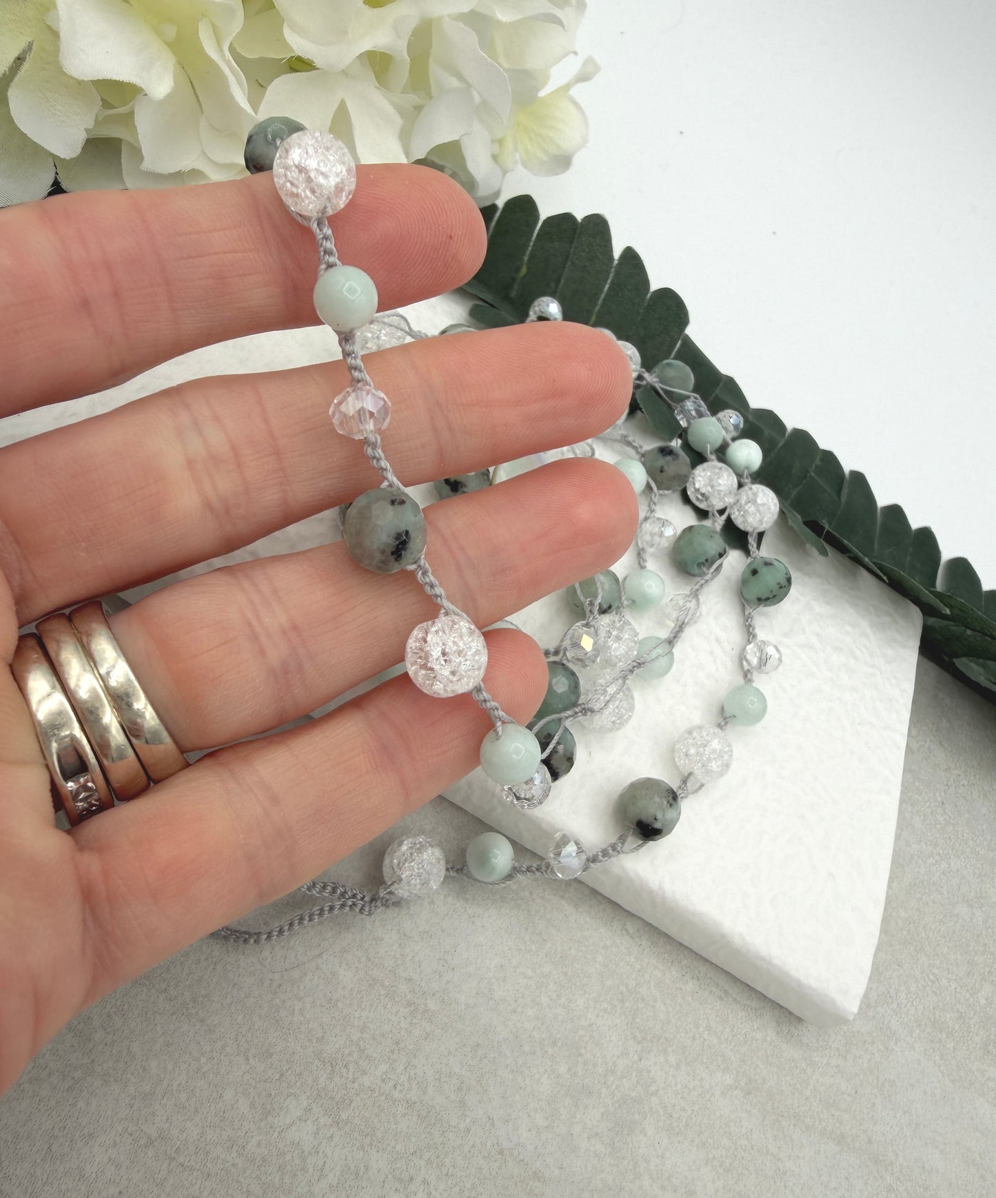A Long Crocheted Necklace with a Light Gray Cord With Agate, Crackled Quartz and Crystal Beads SN-694