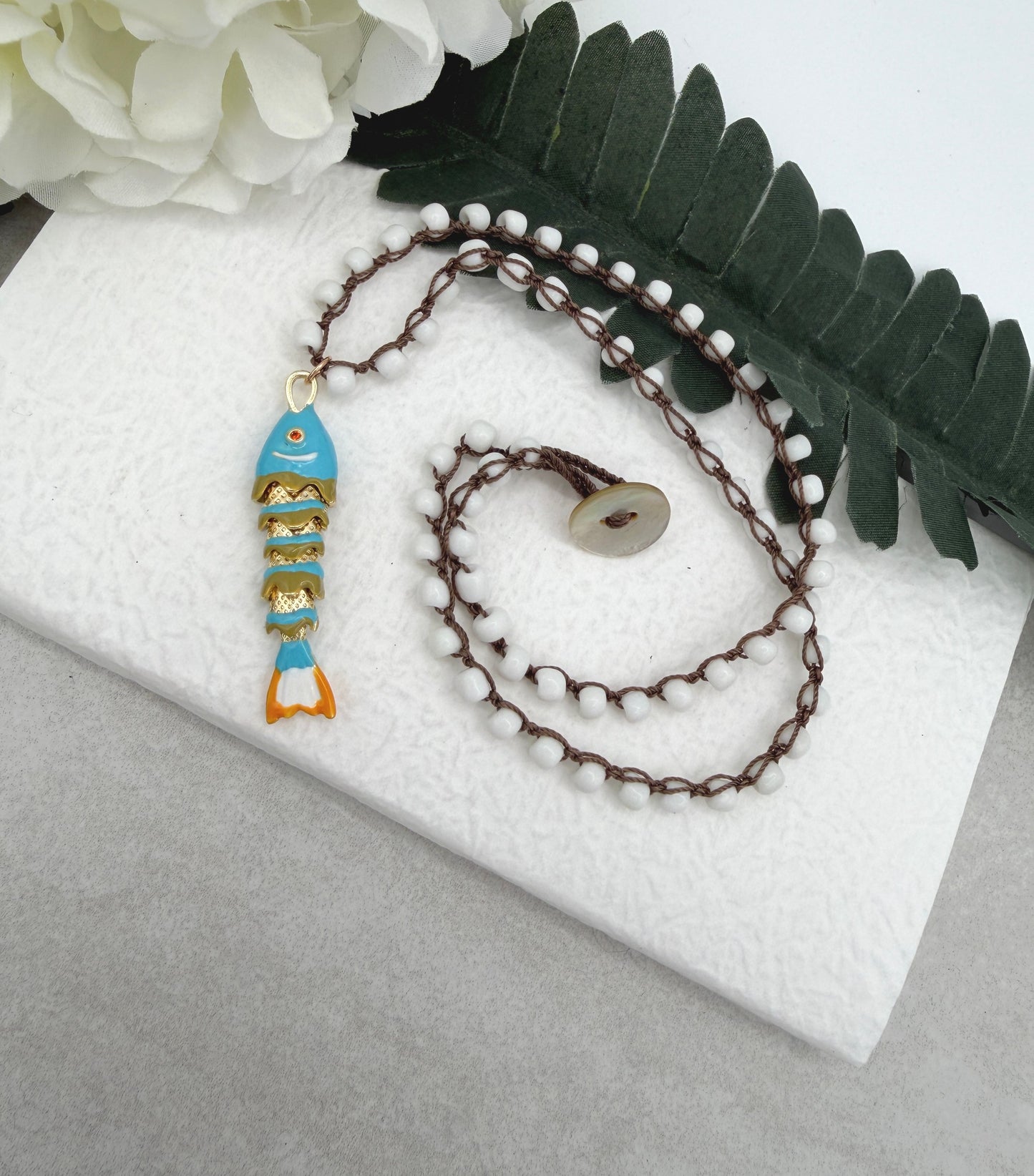 Crocheted Necklace with a Brown Cord, White Glass Beads and a Turquoise, Orangle Enameled Fish Charm SN-695