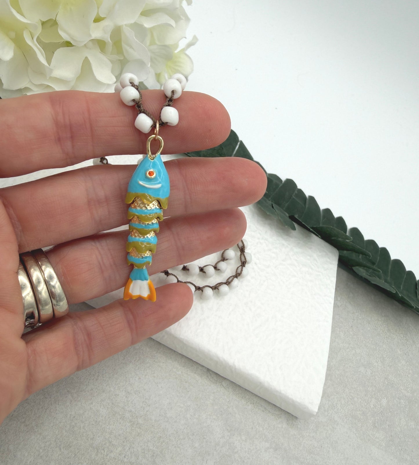 Crocheted Necklace with a Brown Cord, White Glass Beads and a Turquoise, Orangle Enameled Fish Charm SN-695