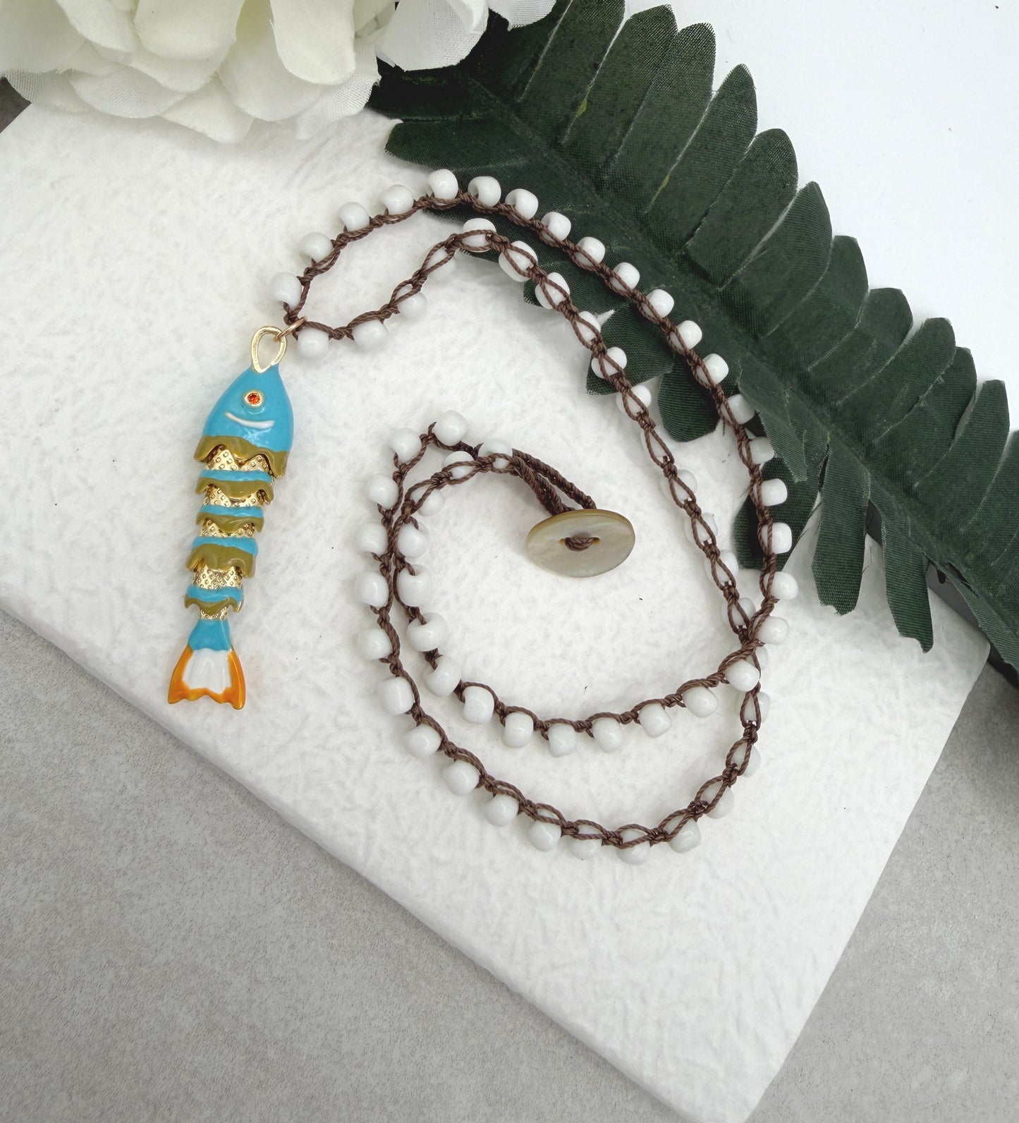 Crocheted Necklace with a Brown Cord, White Glass Beads and a Turquoise, Orangle Enameled Fish Charm SN-695