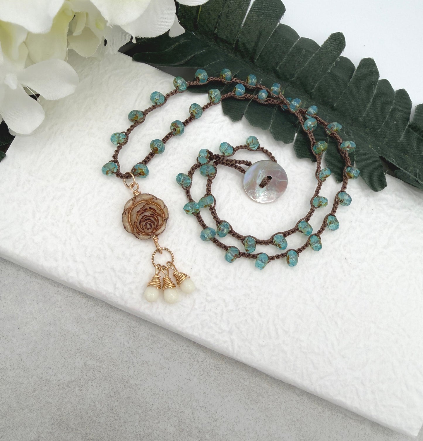 Crocheted Necklace with a Brown Cord, Aqua Glass Beads and a Czech Glass Rose, Braided Loop and Cream Glass Pendant SN-701