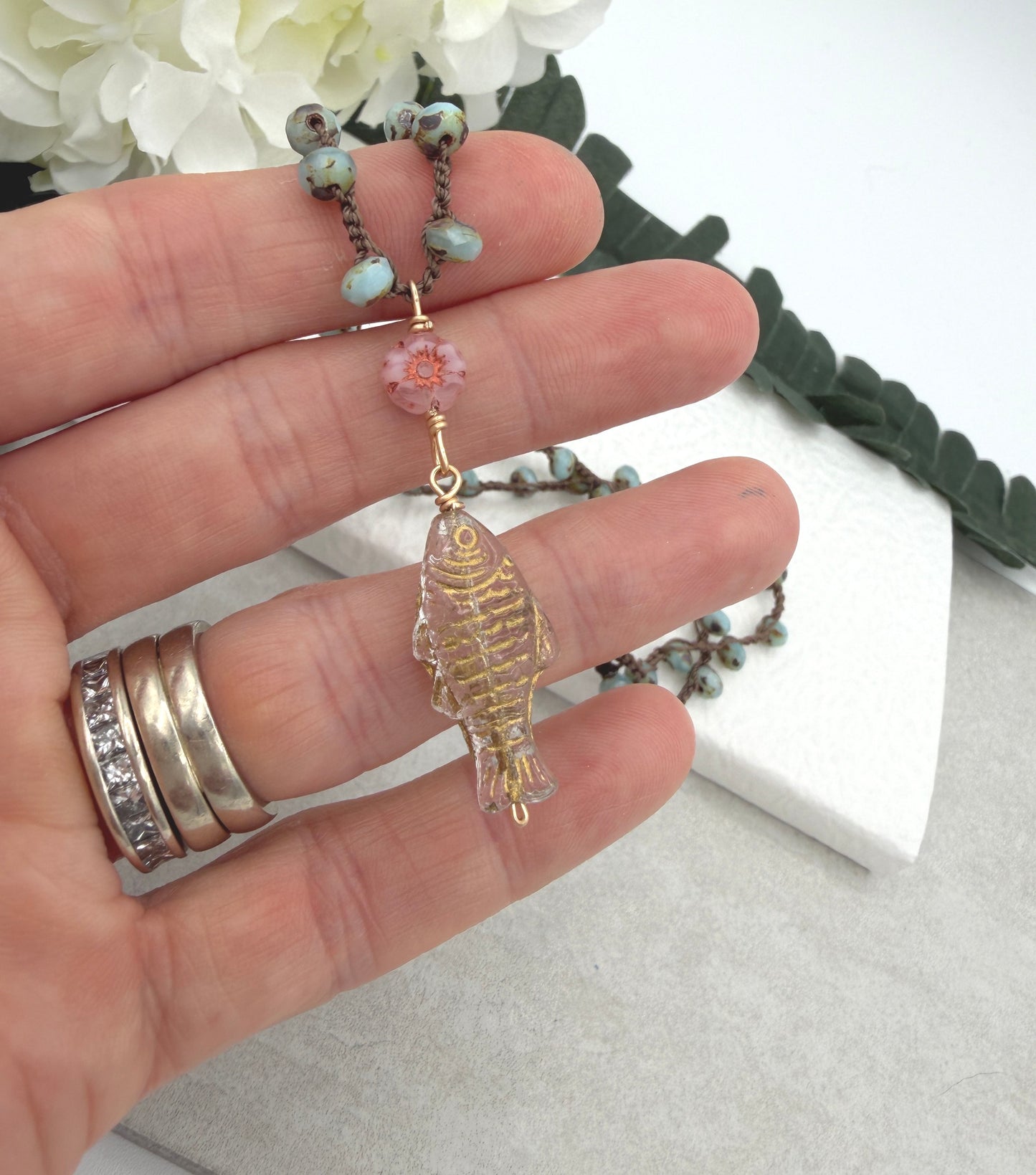 Crocheted Necklace with a Brown Cord, Blue Glass Beads, a Czech Glass Pink Flower, and Gold Glass Fish Bead