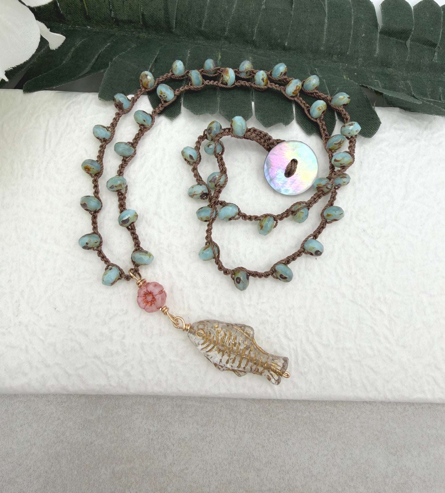 Crocheted Necklace with a Brown Cord, Blue Glass Beads, a Czech Glass Pink Flower, and Gold Glass Fish Bead