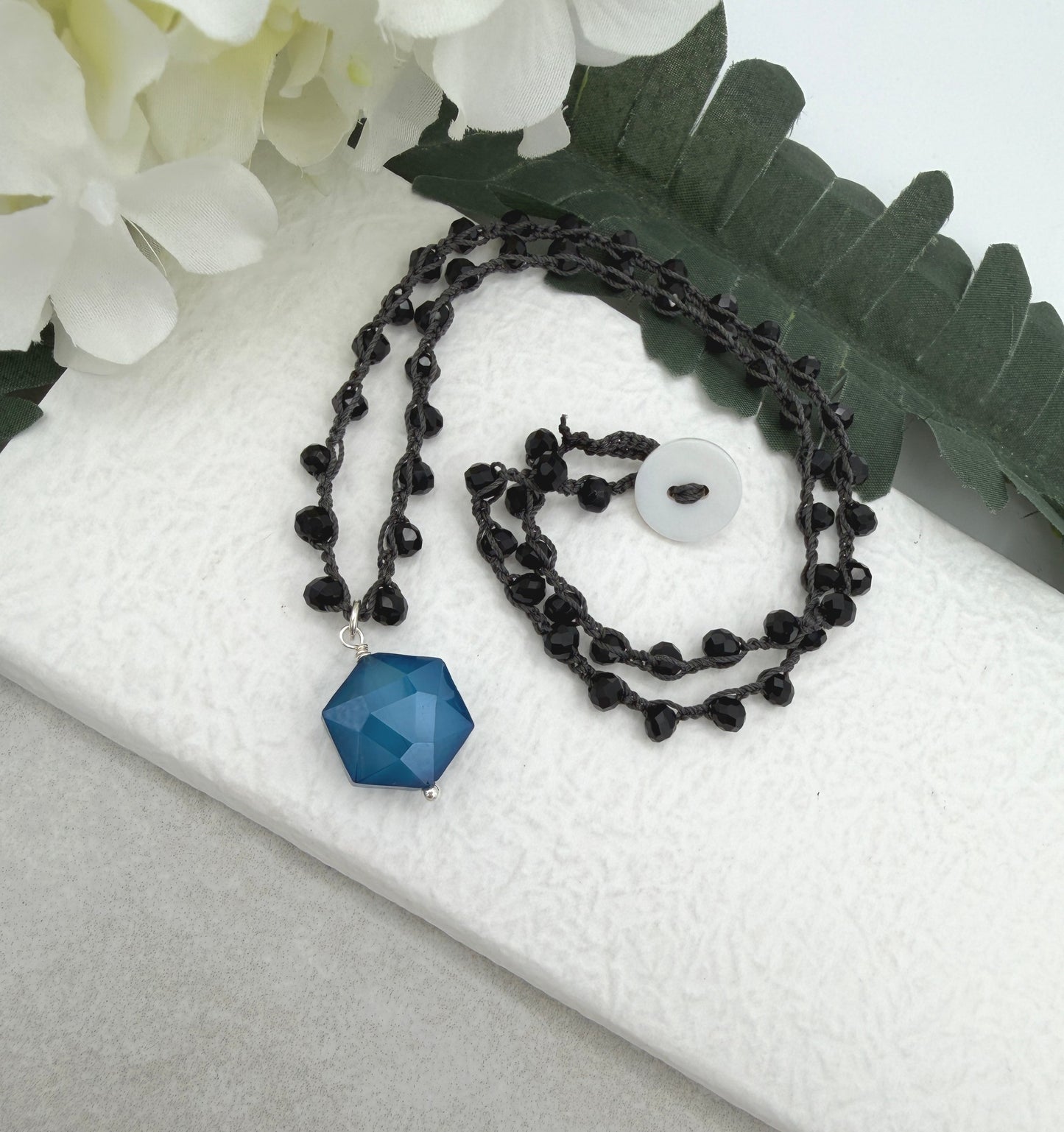 Crocheted Necklace with a Dark Gray Cord, Black Crystal Beads and a Blue Crystal Hexagon Bead Pendant SN-704
