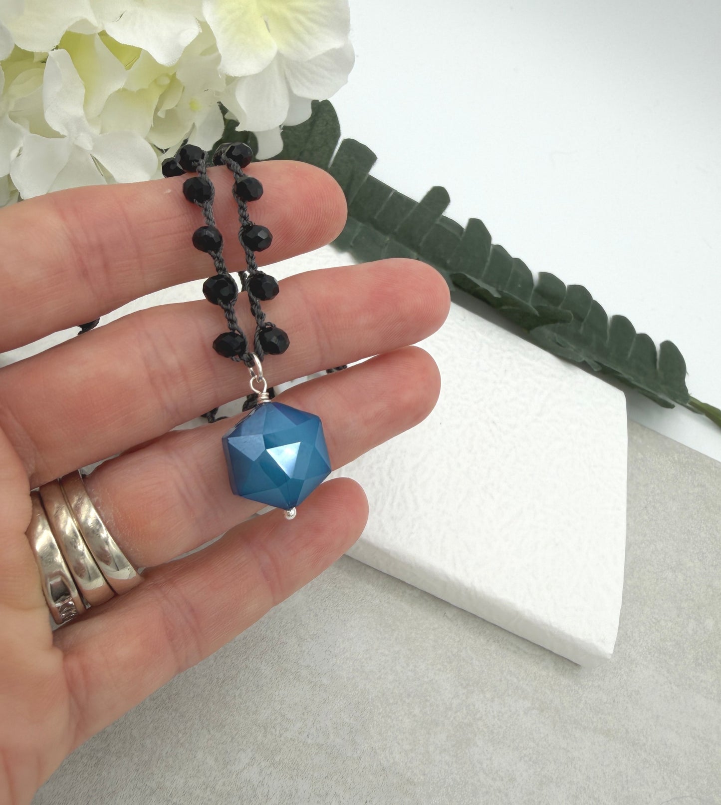 Crocheted Necklace with a Dark Gray Cord, Black Crystal Beads and a Blue Crystal Hexagon Bead Pendant SN-704