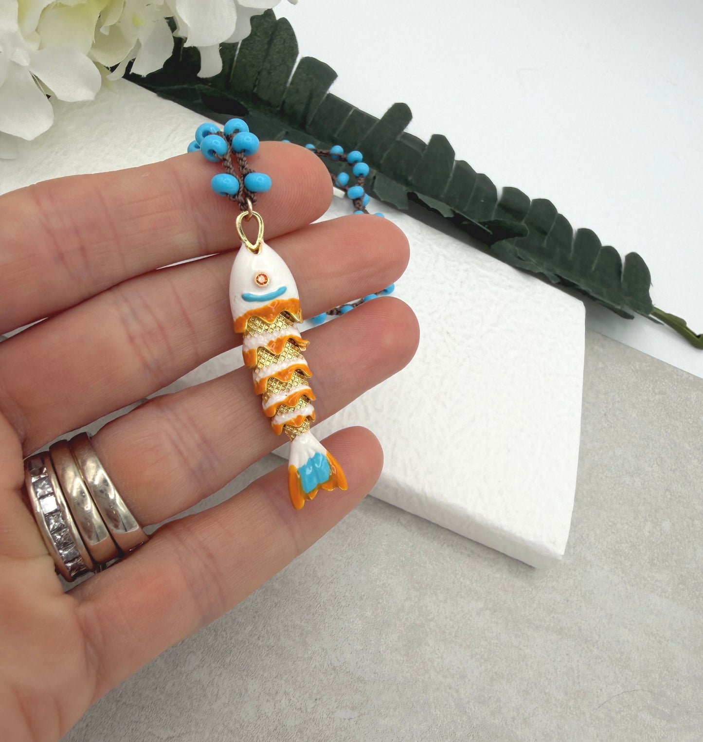 Crocheted Necklace with a Brown Cord, Turquoise Glass Beads and a White, Orangle Enameled Fish Charm SN-705