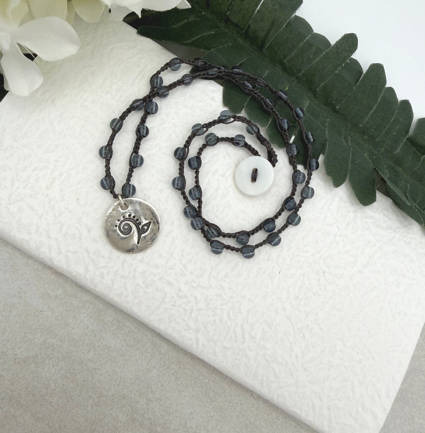 Crocheted Necklace with a Dark Gray Cord, Montana Blue Glass Beads and a Round, PMC Pendant with a Fiddle head Fern SN-707