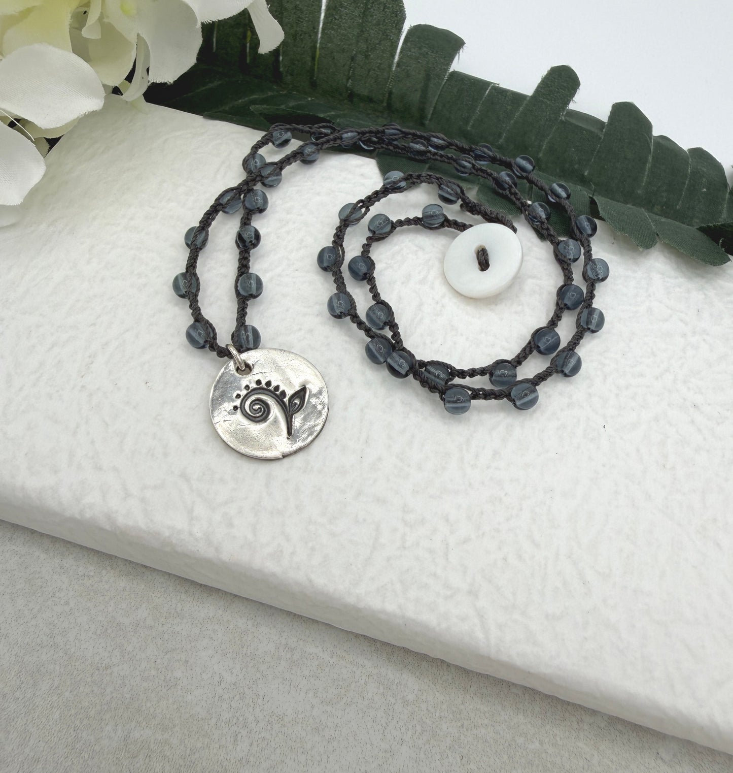 Crocheted Necklace with a Dark Gray Cord, Montana Blue Glass Beads and a Round, PMC Pendant with a Fiddle head Fern SN-707
