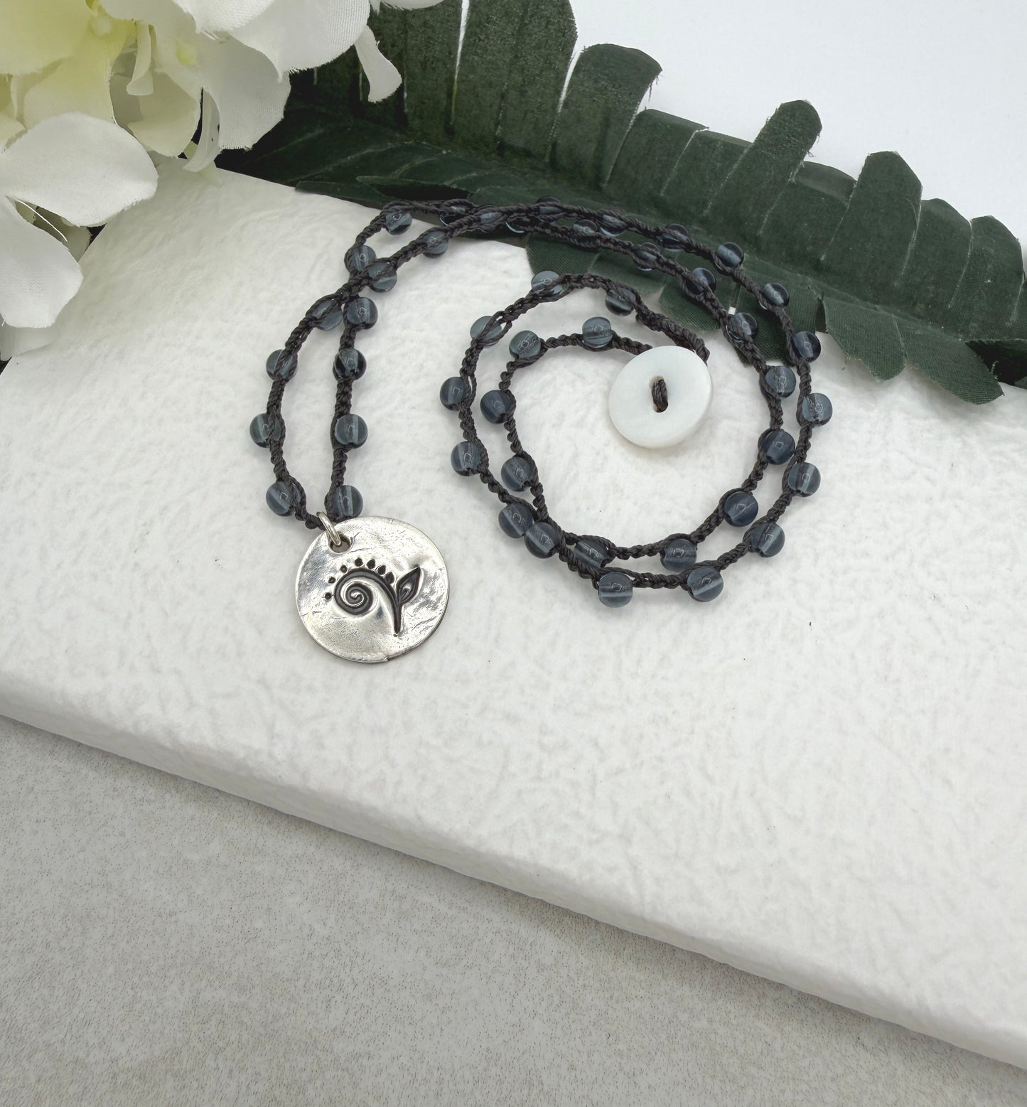 Crocheted Necklace with a Dark Gray Cord, Montana Blue Glass Beads and a Round, PMC Pendant with a Fiddle head Fern SN-707