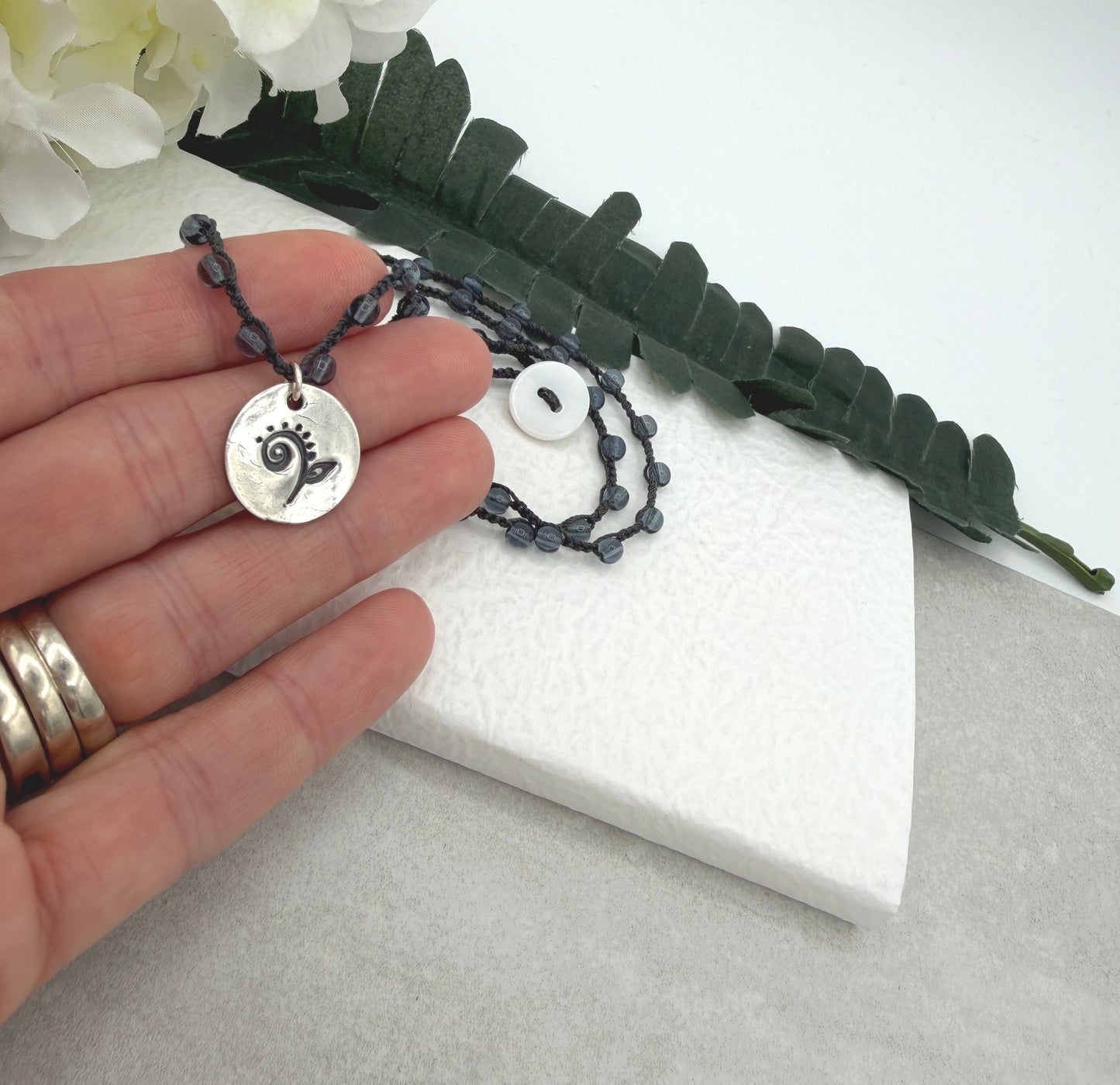 Crocheted Necklace with a Dark Gray Cord, Montana Blue Glass Beads and a Round, PMC Pendant with a Fiddle head Fern SN-707
