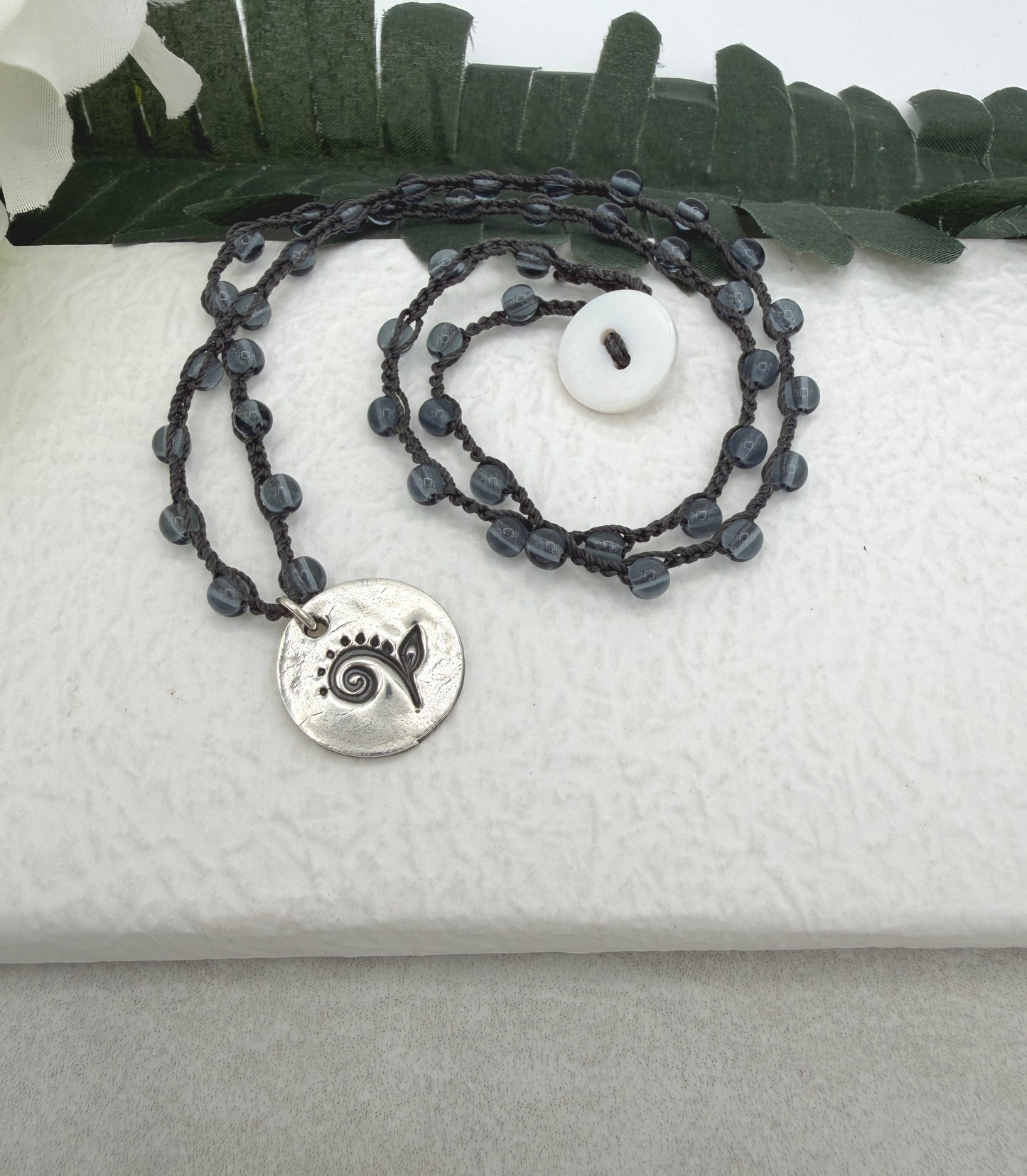 Crocheted Necklace with a Dark Gray Cord, Montana Blue Glass Beads and a Round, PMC Pendant with a Fiddle head Fern SN-707