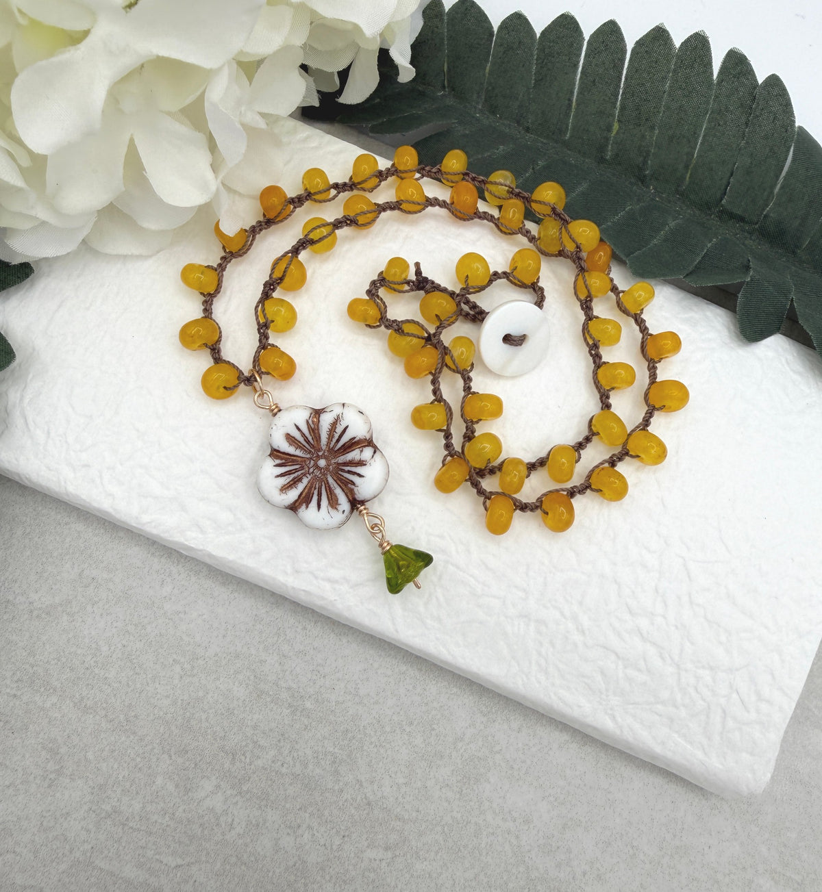 Crocheted Necklace with a Brown Cord, Yellow Jade Rondelles, a White Czech Flower and Green Leaf SN-710