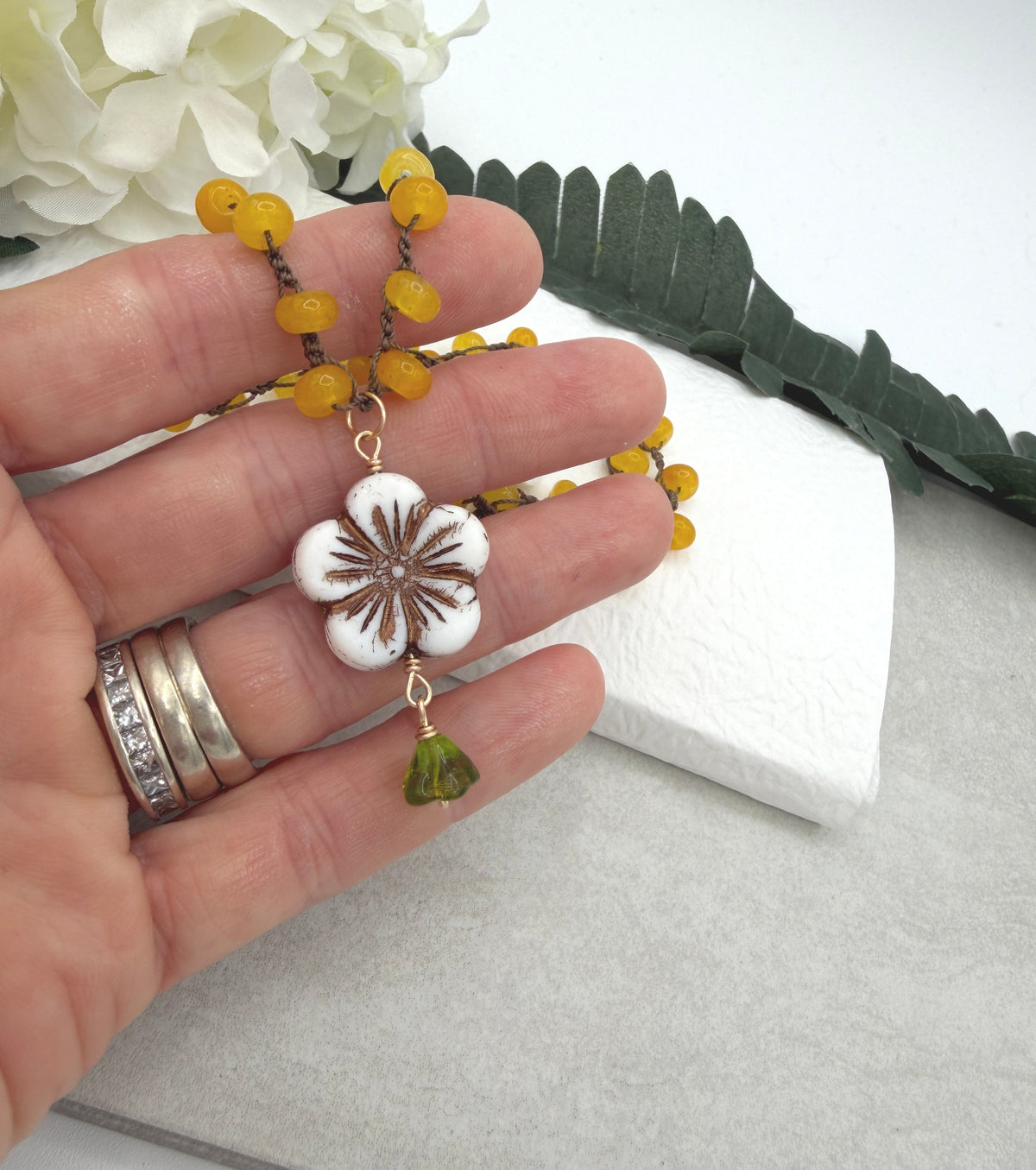 Crocheted Necklace with a Brown Cord, Yellow Jade Rondelles, a White Czech Flower and Green Leaf SN-710