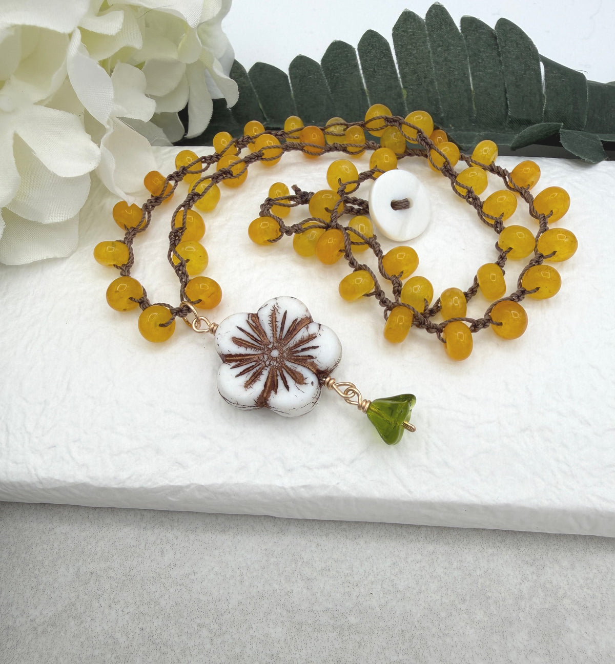 Crocheted Necklace with a Brown Cord, Yellow Jade Rondelles, a White Czech Flower and Green Leaf SN-710