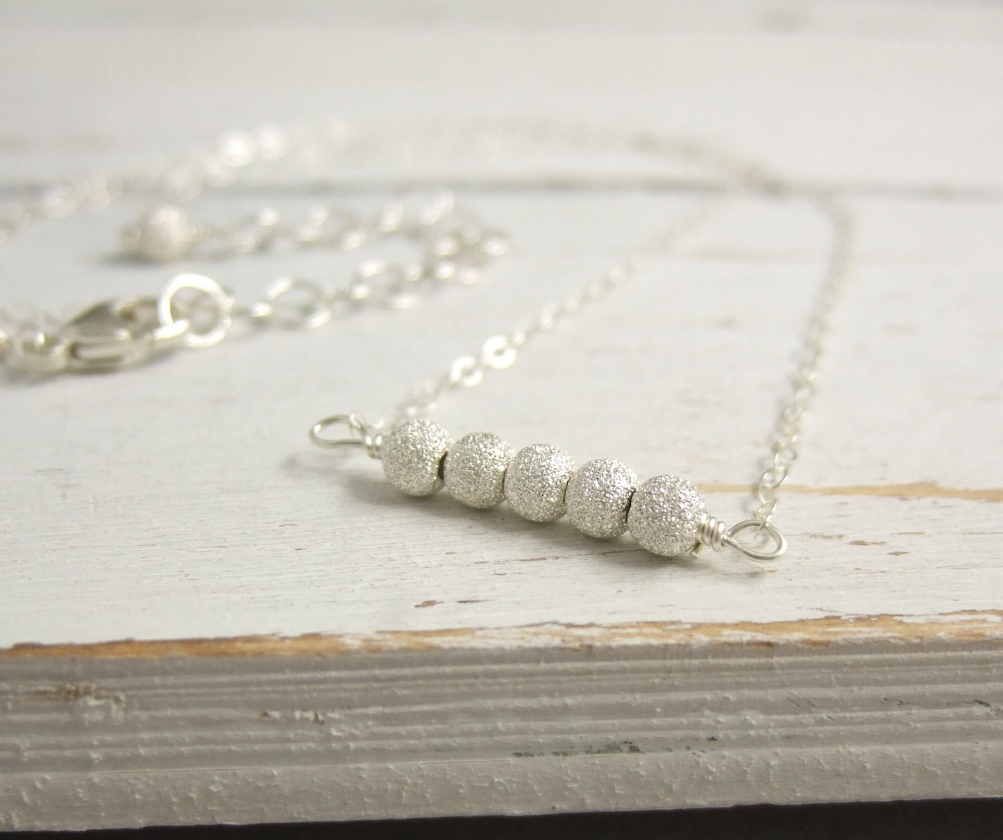 Necklace with a Line of Sterling Silver Stardust Beads, Wire Wrapped to a Sterling Silver Cable Chain CDN-792