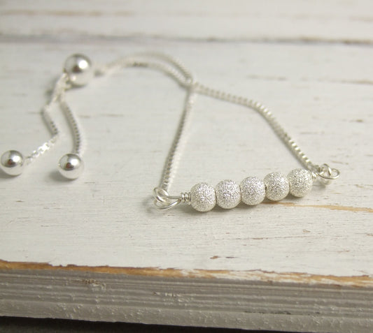 Bracelet with an Adjustable Chain and a Line of Wrapped, Sterling Silver Stardust Beads CB-65