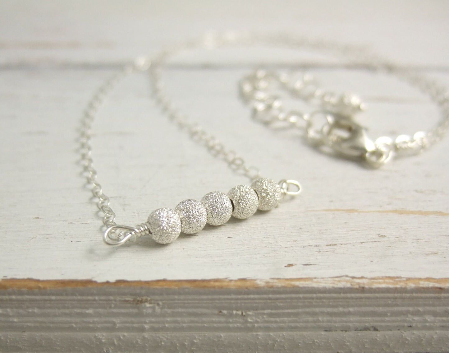 Necklace with a Line of Sterling Silver Stardust Beads, Wire Wrapped to a Sterling Silver Cable Chain CDN-792