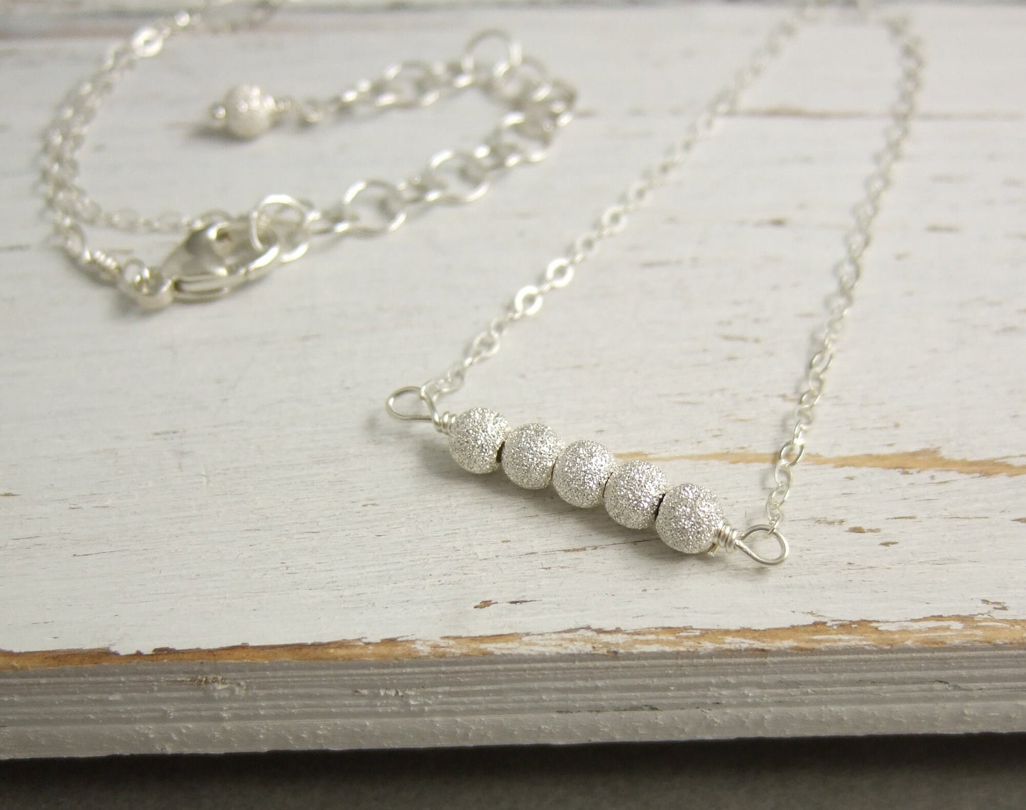 Necklace with a Line of Sterling Silver Stardust Beads, Wire Wrapped to a Sterling Silver Cable Chain CDN-792