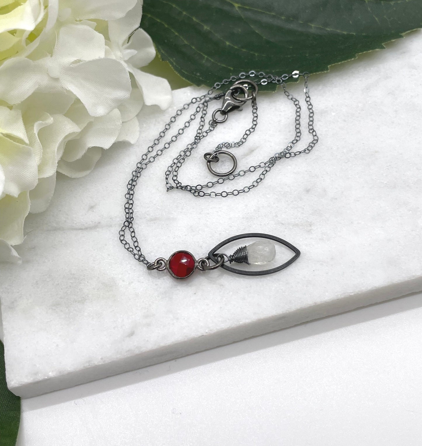 Necklace with an Oxidized Brass Loop, Bezel Set Garnet and Wire Wrapped Moonstone on an Oxidized, Sterling Silver Cable Chain CDN-861
