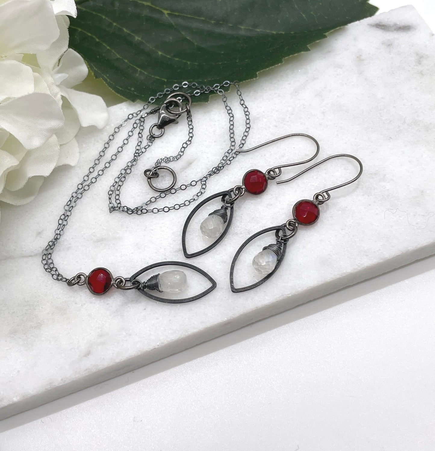 Necklace with an Oxidized Brass Loop, Bezel Set Garnet and Wire Wrapped Moonstone on an Oxidized, Sterling Silver Cable Chain CDN-861