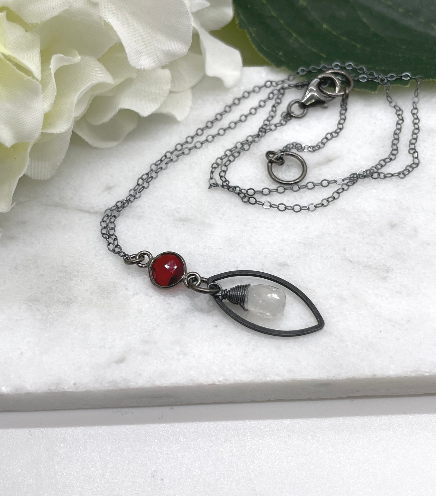 Necklace with an Oxidized Brass Loop, Bezel Set Garnet and Wire Wrapped Moonstone on an Oxidized, Sterling Silver Cable Chain CDN-861