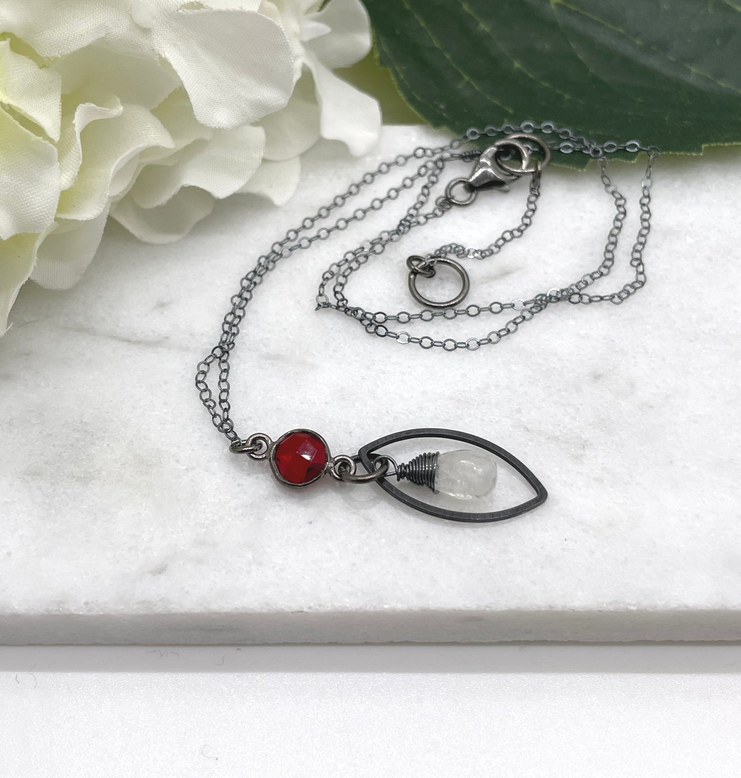 Necklace with an Oxidized Brass Loop, Bezel Set Garnet and Wire Wrapped Moonstone on an Oxidized, Sterling Silver Cable Chain CDN-861