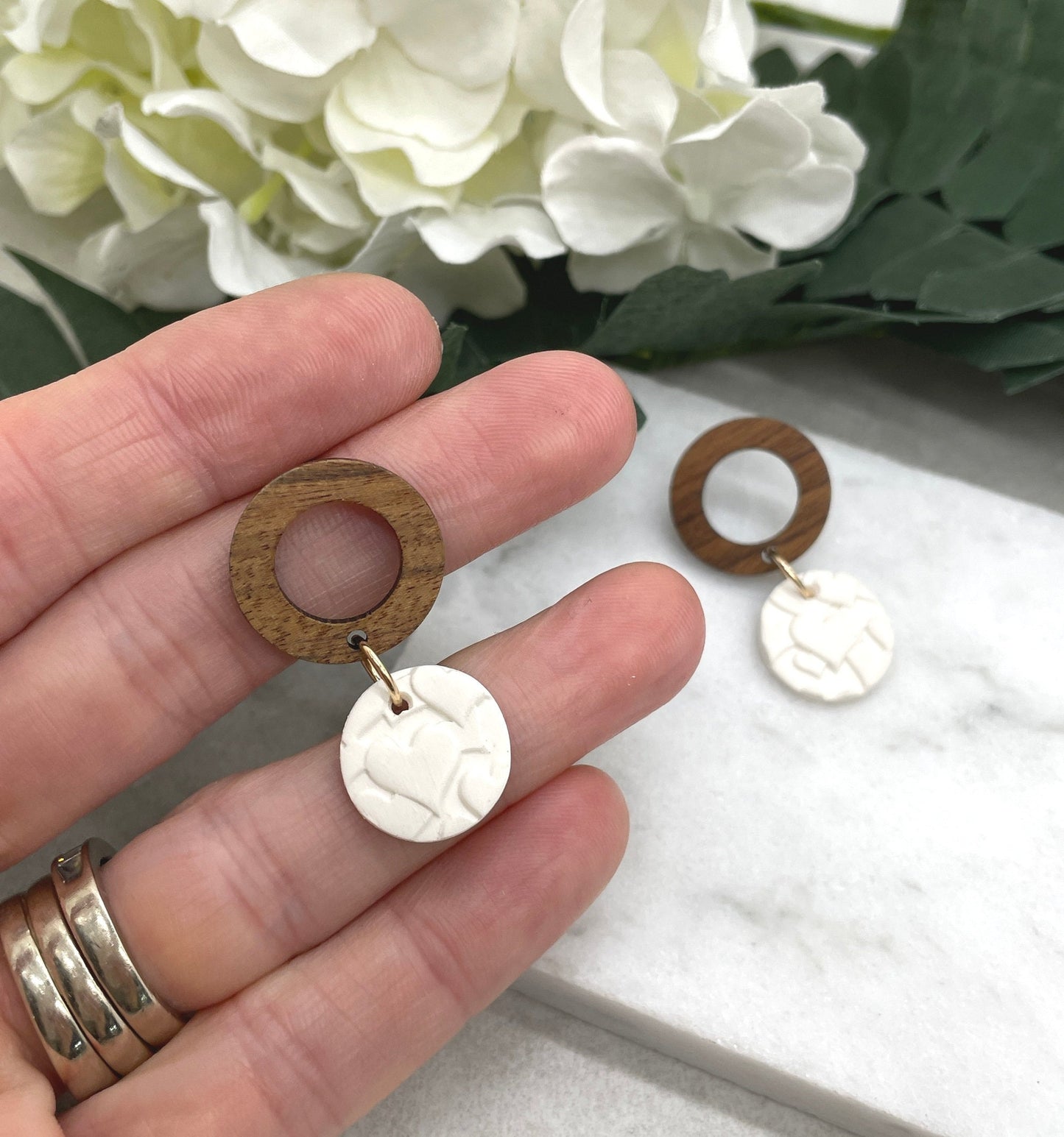Earrings made with White Polymer Clay Circles Textured with Hearts and Wood Circle Posts PCE-612